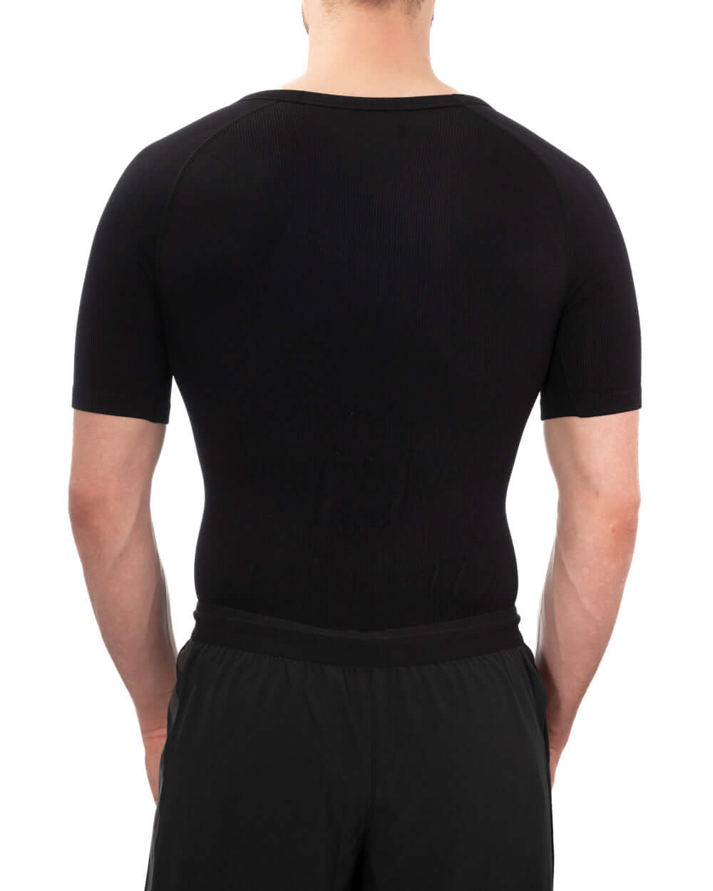 Back view of a man wearing a black short sleeve compression shirt for gynecomastia support.
