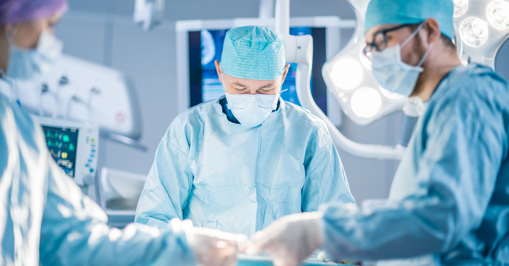 three surgeons in an operating theatre